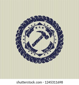 Blue hammer icon inside distressed rubber grunge stamp