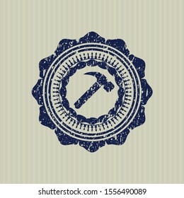 Blue hammer icon inside distressed rubber stamp with grunge texture