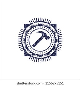 Blue hammer icon inside rubber grunge texture stamp