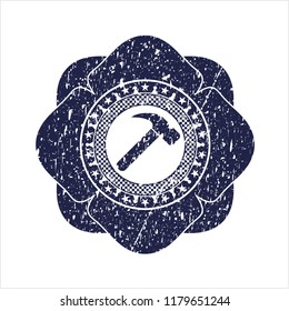 Blue hammer icon inside rubber stamp