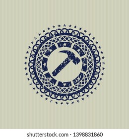 Blue hammer icon inside rubber seal