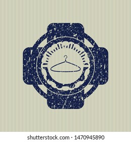 Blue hanger icon inside distressed rubber grunge texture stamp
