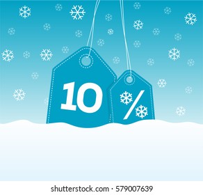 Blue hanging price tag labels with 10% and snowflake percent design texts on them on snow background. For winter sale campaigns.