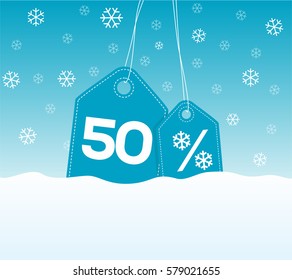 Blue hanging price tag labels with 50% and snowflake percent design texts on them on snow background. For winter sale campaigns.