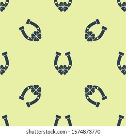 Blue Horseshoe with four leaf clover icon isolated seamless pattern on yellow background. Happy Saint Patricks day.  Vector Illustration