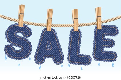 Blue jeans SALE word drying on a clothesline