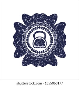 Blue kettlebell icon inside distressed rubber seal