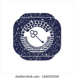 Blue key icon inside grunge seal