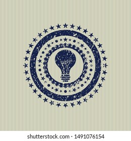 Blue light bulb icon inside distressed rubber seal with grunge texture