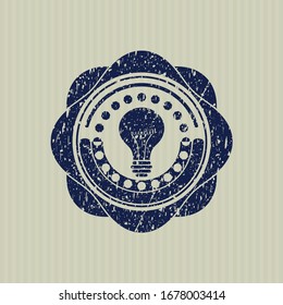 Blue light bulb icon inside rubber grunge texture seal