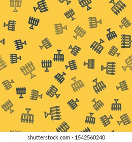 Blue line Hanukkah menorah icon isolated seamless pattern on yellow background. Hanukkah traditional symbol. Holiday religion, jewish festival of Lights.  Vector Illustration
