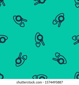 Blue line Magnifying glass with footsteps icon isolated seamless pattern on green background. Detective is investigating. To follow in the footsteps.  Vector Illustration