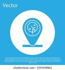 Blue Location and tree icon isolated on blue background. White circle button. Vector Illustration