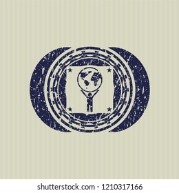 Blue man lifting world icon inside distressed grunge stamp