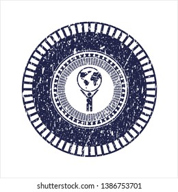 Blue man lifting world icon inside rubber stamp