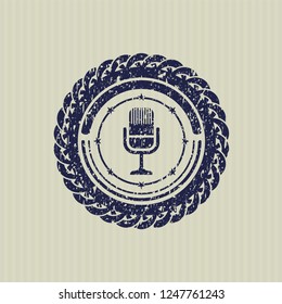 Blue microphone icon inside distressed rubber grunge texture seal