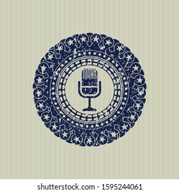 Blue microphone icon inside distressed rubber grunge stamp