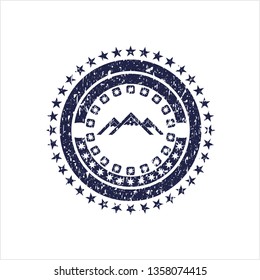 Blue mountain icon inside distress rubber grunge stamp