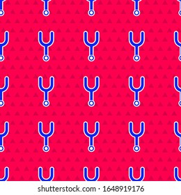 Blue Musical tuning fork for tuning musical instruments icon isolated seamless pattern on red background.  Vector Illustration