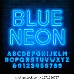 Blue Neon alphabet font. Uppercase neon light letters and numbers. Brick wall background. Stock vector typescript for your typography design.