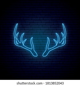 Blue neon horns sign. Glowing deer horns emblem on dark brick wall background. Concept Christmas neon signboard. Vector Illustration.
