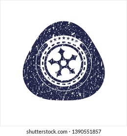 Blue ninja star icon inside rubber grunge seal