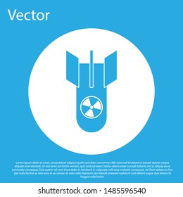 Blue Nuclear bomb icon isolated on blue background. Rocket bomb flies down. White circle button. Vector Illustration