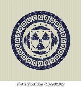 Blue nuclear, radioactive icon inside rubber grunge texture seal