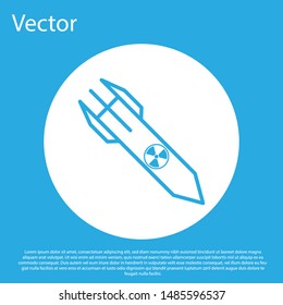 Blue Nuclear rocket icon isolated on blue background. Rocket bomb flies down. White circle button. Vector Illustration