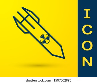 Blue Nuclear rocket icon isolated on yellow background. Rocket bomb flies down.  Vector Illustration