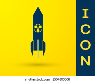 Blue Nuclear rocket icon isolated on yellow background. Rocket bomb flies down.  Vector Illustration