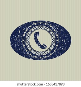 Icono azul del teléfono viejo dentro de un sello de goma con textura gruesa