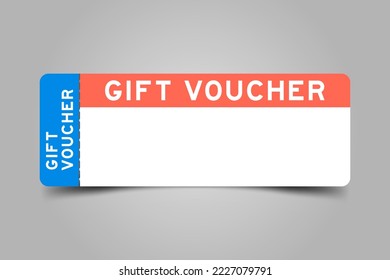 Blue and orange color ticket with word gift voucher and white copy psace on gray background