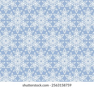 Blue ornament pattern with snowflakes. Seamless design. Graphic background with snow elements. Blue and white repetitive boho illustration for decoration. Winter flora wallpaper art. Digital paper.