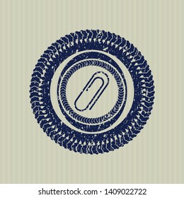 Blue paper clip icon inside distressed rubber grunge seal