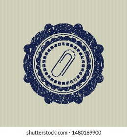 Blue paper clip icon inside rubber grunge texture stamp