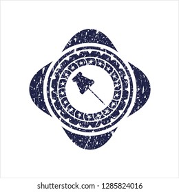 Blue paper pin icon inside distressed rubber seal
