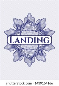 Blue passport style rosette with text Landing inside