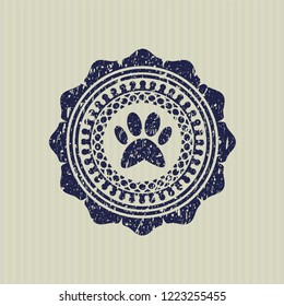 Blue paw icon inside distressed rubber stamp with grunge texture