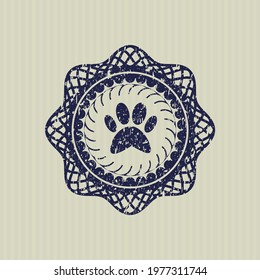 Blue paw icon inside distressed with rubber seal texture. 