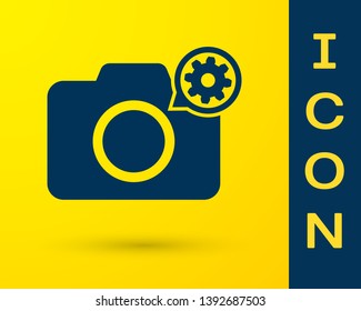 Blue Photo camera and gear icon isolated on yellow background. Adjusting app, service concept, setting options, maintenance, repair, fixing. Vector Illustration