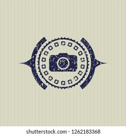 Blue photo camera icon inside distressed rubber texture