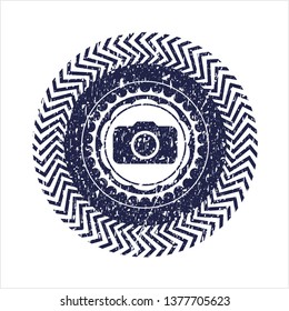 Blue photo camera icon inside distress rubber seal