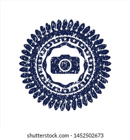 Blue photo camera icon inside distressed rubber grunge texture stamp
