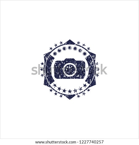 Blue photo camera icon inside rubber stamp