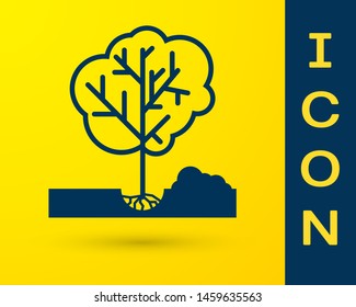 Blue Planting a tree in the ground icon isolated on yellow background. Gardening, agriculture, caring for environment.  Vector Illustration