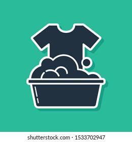 Blue Plastic basin with soap suds icon isolated on green background. Bowl with water. Washing clothes, cleaning equipment.  Vector Illustration