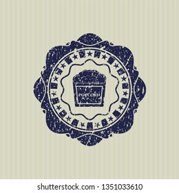 Blue popcorn icon inside rubber stamp with grunge texture