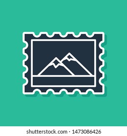 Blue Postal stamp and Mountains icon isolated on green background.  Vector Illustration