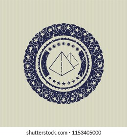 Blue pyramids icon inside rubber grunge texture stamp